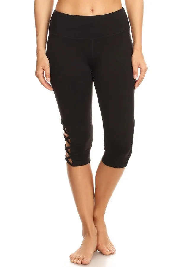 Black hi-rise Capri with a side crisscross strap cutout